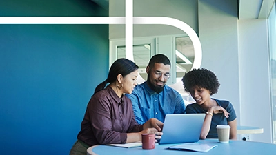 three people looking at a computer