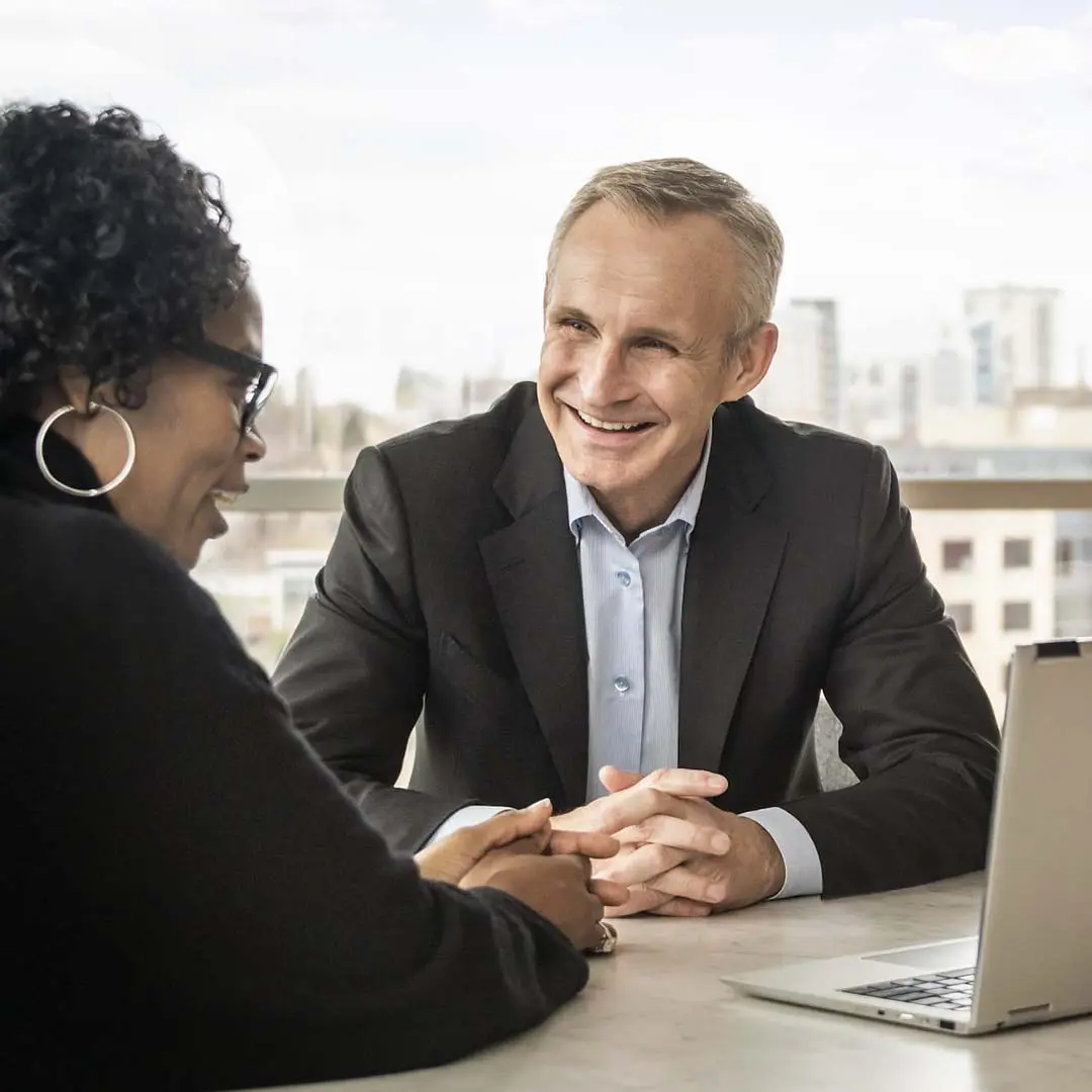 Jonas Prising sitting in office talking to work colleague